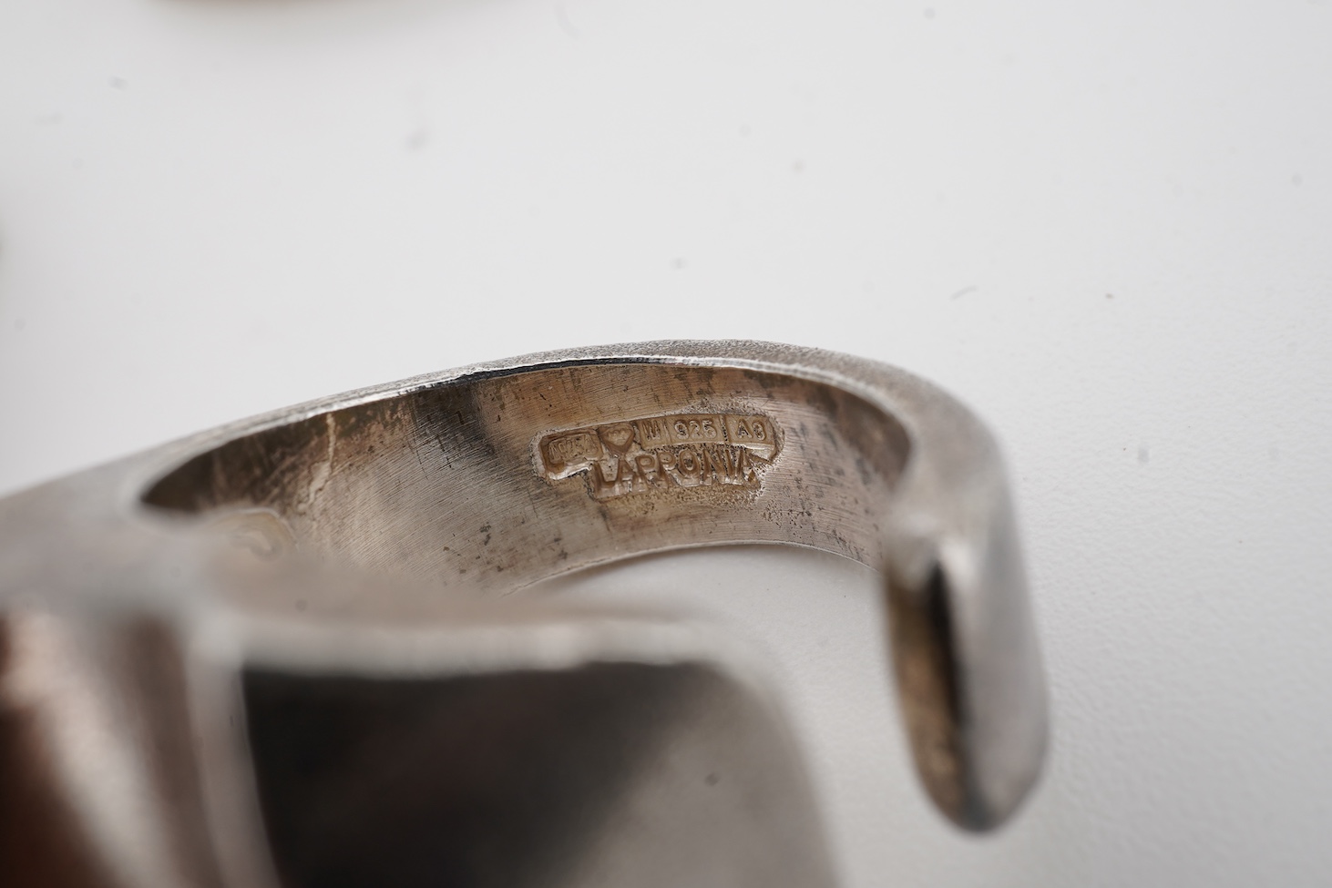 Two contemporary Finnish Lapponia 925 rings, sizes O and U, together with a similar Finnish Lapponia 925 brooch.